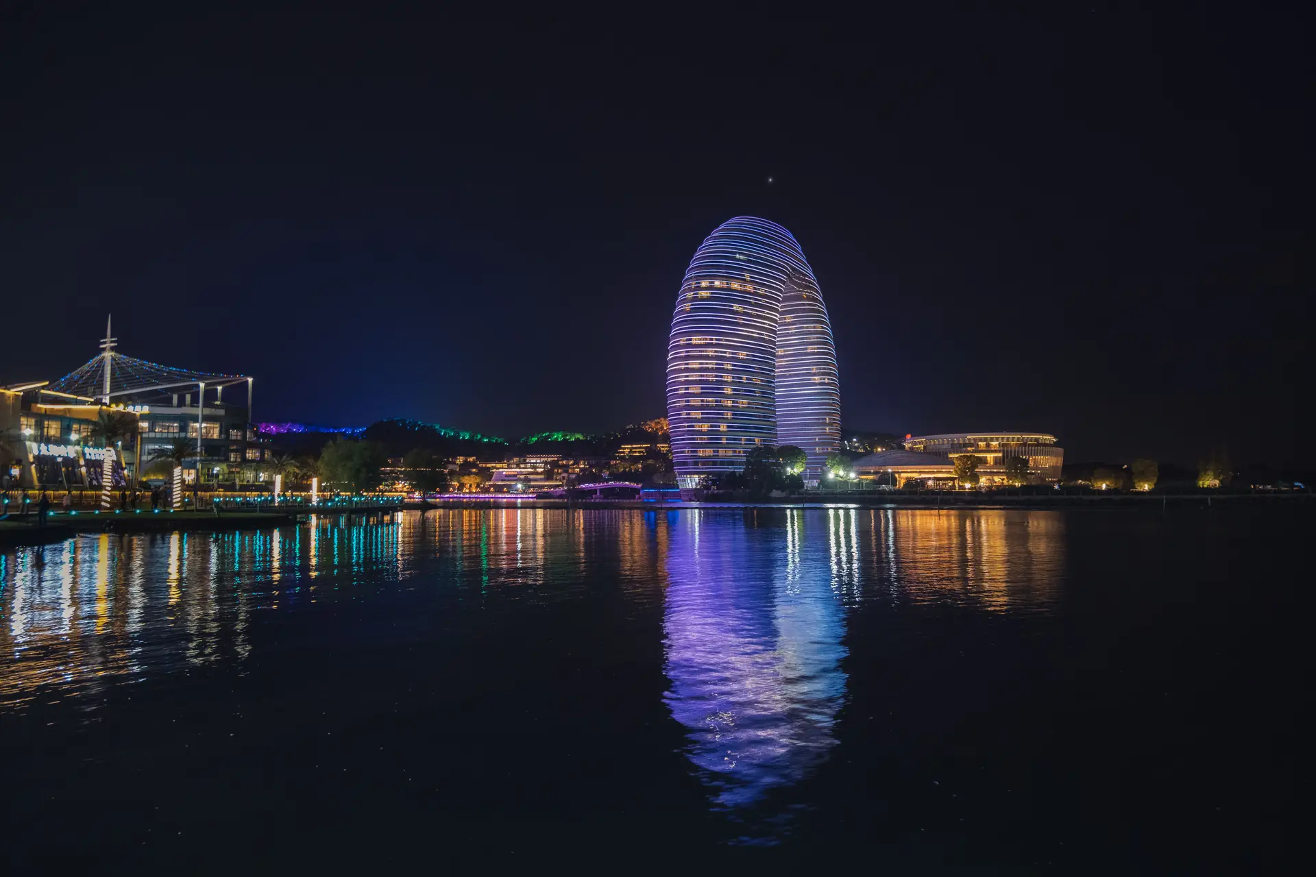 Canadian destination resort architecture reflecting over tranquil water at twilight
