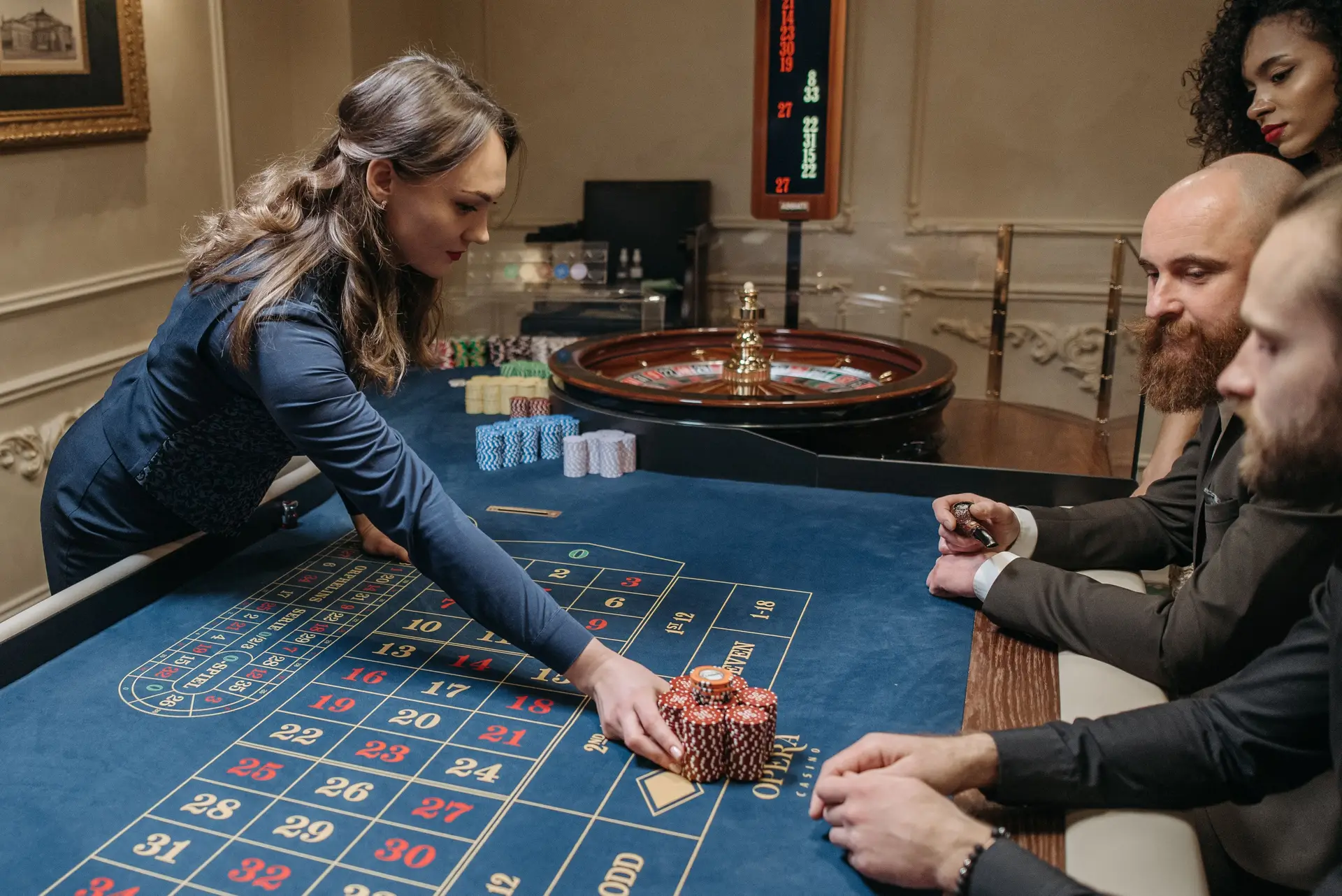 Guests socializing politely with casino dealer at gaming table
